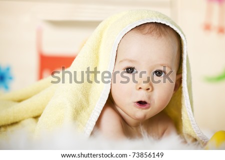 stock photo Portrait of sweet naked baby boy with yellow towel on head 
