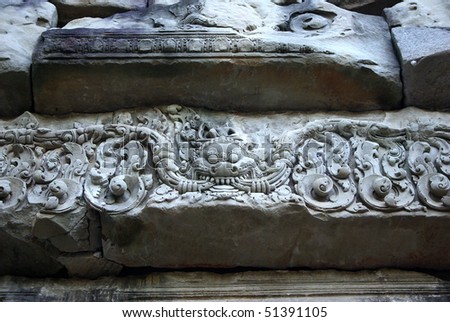 Close-up of an engraved grey stone of a temple in Angkor