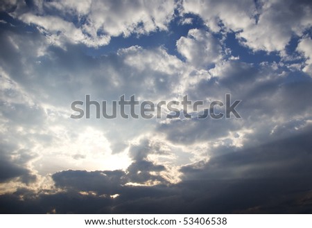 Big rays of light with many clouds and blue sky