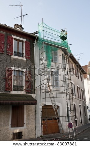 Scaffolding fixed on a facade in a little street