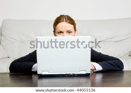 Young businesswoman behind laptop at the table
