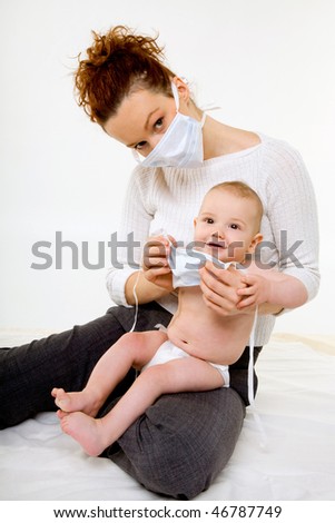 young mother in a protective mask with her baby