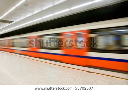 Fast train passing by train station. Motion blurred.