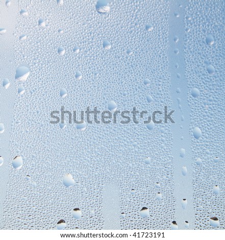 Water droplets in front of a blue sky background