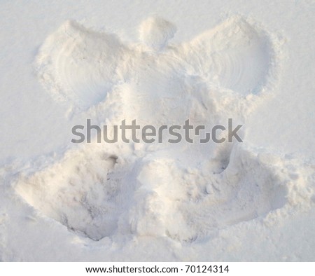 A snow angel made in the white snow.