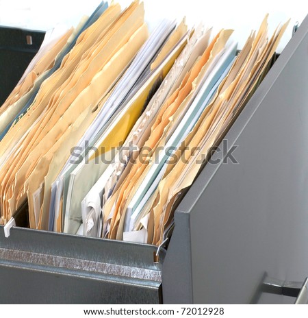 A file cabinet drawer full of files and folders