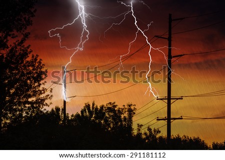 Silhouette of Power Lines being struck by lightning.