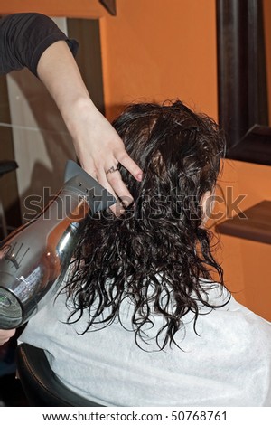 Woman with wet hair in hair salon having treatment