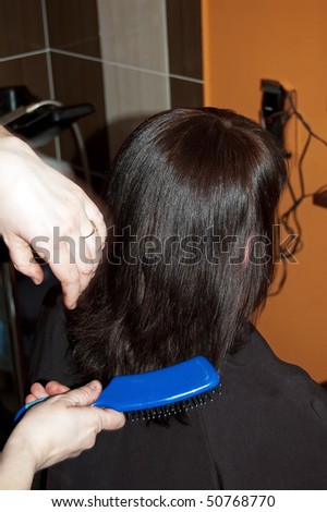 Stylist work on woman hair in salon