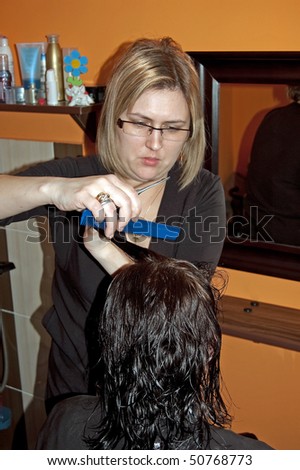 Stylist work on woman hair in salon