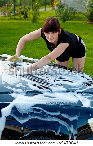 Adult cleaning her car outside