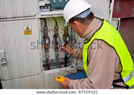 Electrician in studying the current-voltage switchgear and state electrical