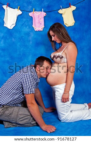 pregnant woman to her husband explaining how it will be after the birth in the blue mosaic background