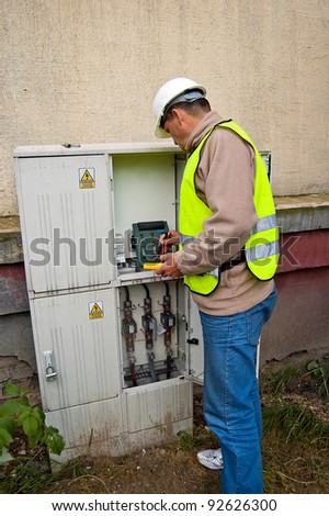 Electrician checking the condition of wiring and electricity meters for the electrical boxes.