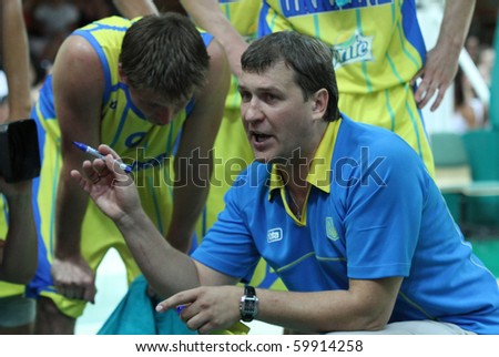 YUZHNE, UKRAINE - AUG 02: Ukraine national team coach Vitaliy Cherniy talks to his team during time out in a EuroBasket qualification match with Macedonia August 02, 2010 in Yuzhne. Ukraine lost 71:58