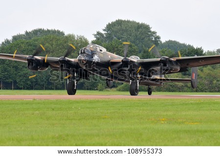 FAIRFORD, UK - JULY 8: Royal Air Force Lancaster aircraft participates in the Royal International Air Tattoo airshow event July 8, 2012 near Cirencester, England.
