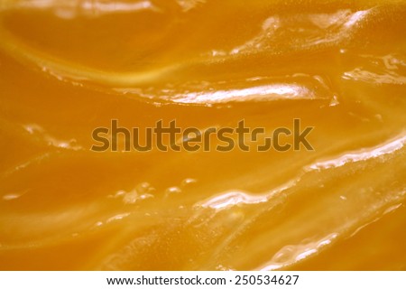 Extreme closeup of orange showing fruit flesh, pith and skin on white background