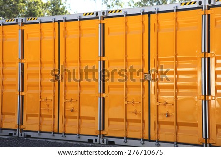 A line of yellow and grey metal storage containers