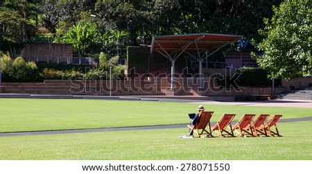 Relaxing garden chairs in garden setting surrounded by grass