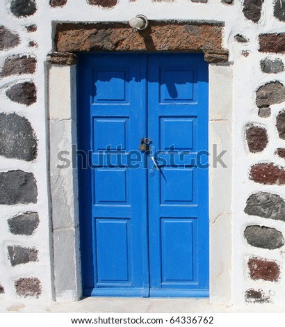blue door set in a rock wall