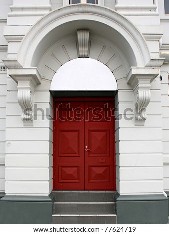 red door in a white arch