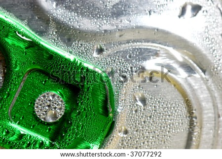 Close up of a metal pop top from a beverage can with drops