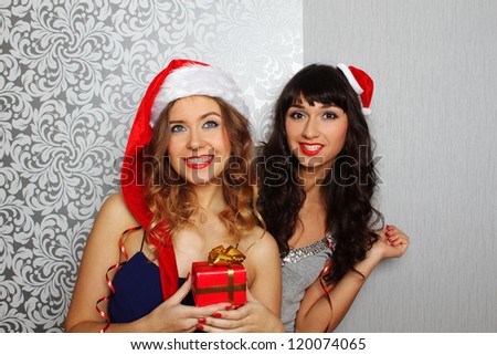 Close-up girlfriends hold gifts at christmas party