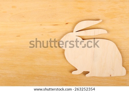Close-up of rabbit silhouette on a wood background
