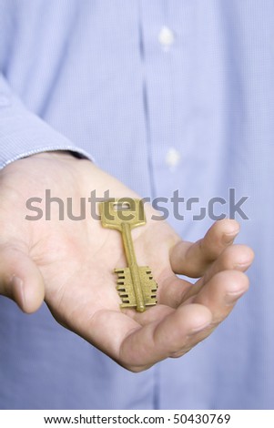 Keys to the house in the palm of a young man in a blue shirt