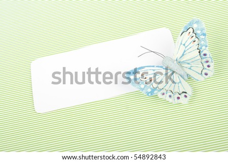 Blank note cards on a green background and a butterfly