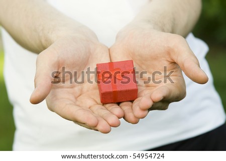 Red gift box in the hands of young men