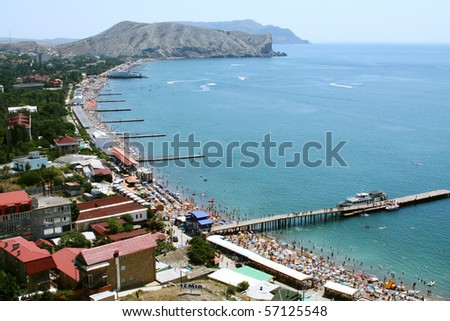 Rocks of the Black Sea coast. Crimea. Sudak. The roofs of the city