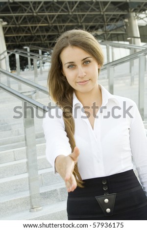 Young and confident business woman invites you to say hello. He holds out his hand