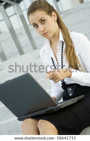 Business woman running on a laptop and was surprised points his finger to a computer