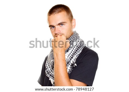 Young man dressed in black t-shirt at the neck of a Palestinian scarf. Stubble on his face. Shows a fist in the frame. Isolated