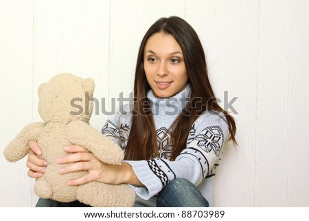Attractive young woman at home with Teddy bears