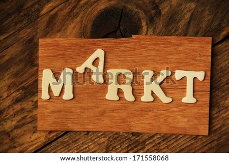 the German word MARKT ( market ) on wood