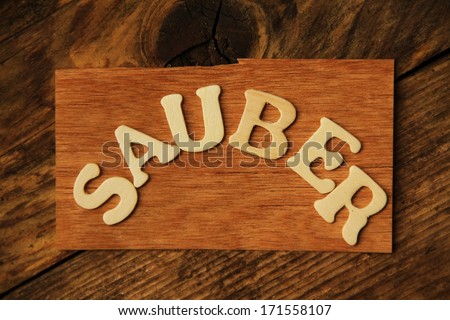 the German word SAUBER ( clean) on wood