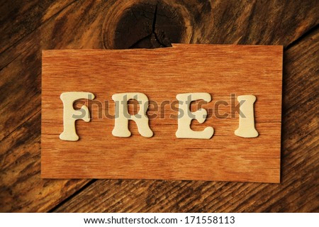 the German word FREI ( free / open ) on wood