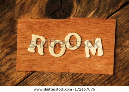 the english word ROOM on wood