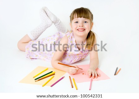 Cute child draw with colorful crayons and smile, isolated over white