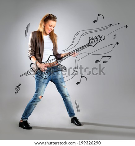 Woman listening to music on mp3 player, dancing playing air guitar. Funny happy portrait of business woman isolated on white background in full length.