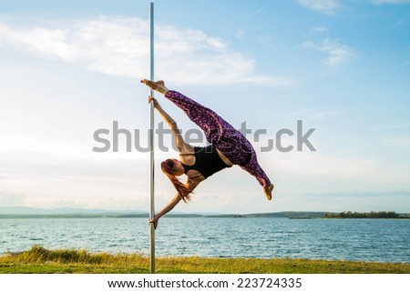 Young sexy woman exercise pole dance