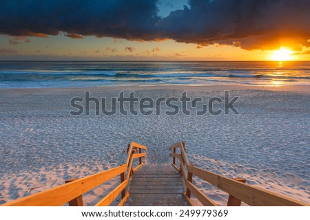 Australian beach entry with stairs in foreground at sunrise (Gold Coast, Mermaid Beach, QLD, Australia)