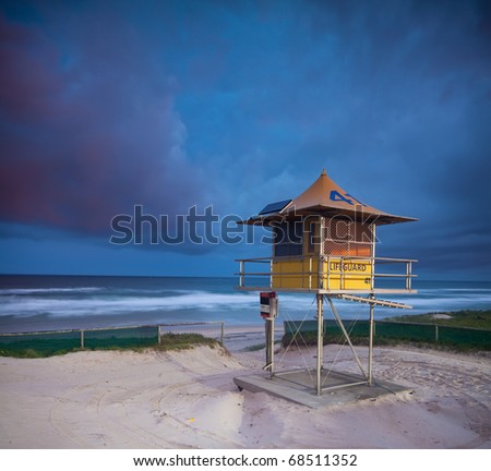 australian beach at twilight with lifeguard hut in foreground