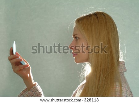 Blonde girl looking into mirror