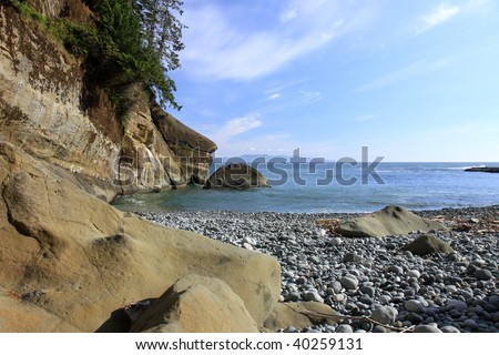 Rocky beach with sandstone cliff along the West Coast Trail located on Vancouver Island in British Columbia