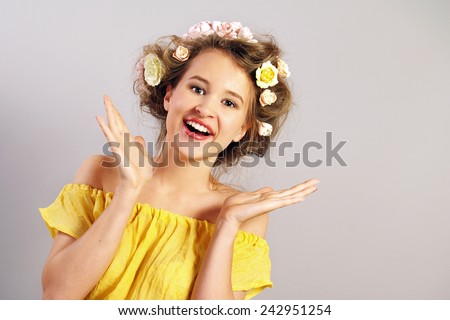 The beautiful joyful girl with flowers in the head