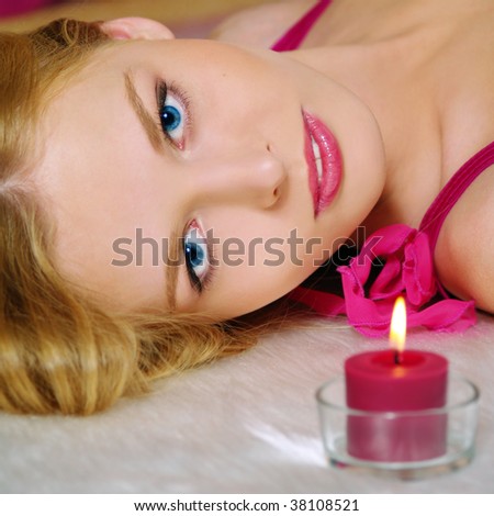 Beautiful young woman with candle, closeup