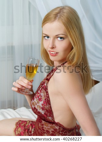 Portrait of beautiful  young women with wine at home